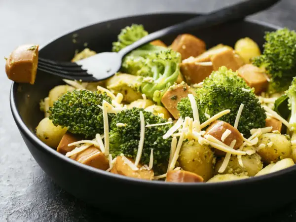 Ein schnelles Gericht mit Kartoffeln, Brokkoli und Würstchen, bestreut mit Käse. Perfekt für Rezepte mit wenig Zutaten.